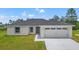 Newly constructed one-story home with gray roof and attached garage at 7128 Sw 134Th St, Ocala, FL 34473