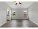 Spacious main bedroom with ceiling fan, two windows, and en-suite bathroom access at 7128 Sw 134Th St, Ocala, FL 34473
