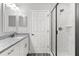 Bathroom with granite countertop, white cabinets, and a frameless shower at 7128 Sw 134Th St, Ocala, FL 34473