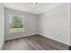 Bedroom featuring a large window and vinyl plank flooring at 7128 Sw 134Th St, Ocala, FL 34473