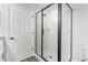 Bathroom with frameless glass shower and marble-look tile at 7128 Sw 134Th St, Ocala, FL 34473