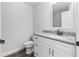 Bathroom features granite countertop, white cabinets, and a sink at 7128 Sw 134Th St, Ocala, FL 34473