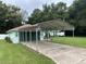 Light green house with carport and well-maintained lawn at 6690 Cherry Rd, Ocala, FL 34472
