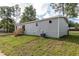 Gray manufactured home with wood stairs and AC unit at 16231 Sw 20Th Ln, Ocala, FL 34481