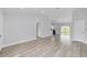 Open concept living area with light walls and wood-look vinyl flooring at 13625 Sw 107 Pl, Dunnellon, FL 34432
