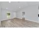 Living room with gray walls, vinyl flooring, and access to other rooms at 13625 Sw 107 Pl, Dunnellon, FL 34432