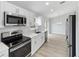 Clean kitchen with stainless steel appliances and white cabinets at 13625 Sw 107 Pl, Dunnellon, FL 34432