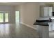 Open living room and kitchen with grey tile floors at 7088 Sw 179Th Court Rd, Dunnellon, FL 34432