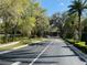 Asphalt road leads to the entrance of the community at 7088 Sw 179Th Court Rd, Dunnellon, FL 34432