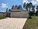 Two-story house with a three car garage and landscaped yard at 7088 Sw 179Th Court Rd, Dunnellon, FL 34432