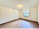 Simple bedroom with wood-look floors and a window at 26 Juniper Pass Ln, Ocala, FL 34480