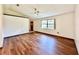 Light-filled living room showcasing wood-look floors and high ceilings at 26 Juniper Pass Ln, Ocala, FL 34480
