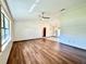Spacious living room with wood-look floors and large windows at 26 Juniper Pass Ln, Ocala, FL 34480