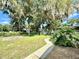 Large backyard with shed, lush landscaping, and a patio area at 26 Juniper Pass Ln, Ocala, FL 34480