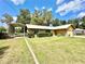Charming home showcasing a carport and lush green lawn at 26 Juniper Pass Ln, Ocala, FL 34480