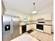 Kitchen features stainless steel refrigerator and white cabinets at 26 Juniper Pass Ln, Ocala, FL 34480