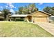 Inviting ranch-style home with a two-car garage and well-maintained lawn at 26 Juniper Pass Ln, Ocala, FL 34480