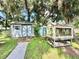 Two storage sheds in the backyard, one appears to be a greenhouse at 26 Juniper Pass Ln, Ocala, FL 34480