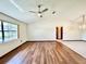 Bright living room featuring wood-look floors and a ceiling fan at 26 Juniper Pass Ln, Ocala, FL 34480
