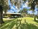 Large backyard with shed, mature trees, and a partially fenced area at 26 Juniper Pass Ln, Ocala, FL 34480