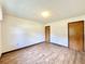 Spacious bedroom with wood-look floors and two doors at 26 Juniper Pass Ln, Ocala, FL 34480
