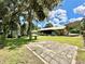 Spacious backyard with large trees, patio, and shed at 26 Juniper Pass Ln, Ocala, FL 34480