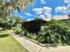 Spacious screened porch with lush tropical plants at 26 Juniper Pass Ln, Ocala, FL 34480