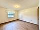 Simple bedroom with wood-look floors and a window at 26 Juniper Pass Ln, Ocala, FL 34480