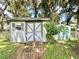 Rustic wooden storage shed with a weathered appearance at 26 Juniper Pass Ln, Ocala, FL 34480