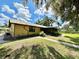 Ranch-style home with screened porch, mature trees, and a spacious backyard at 26 Juniper Pass Ln, Ocala, FL 34480