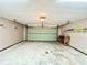 Large garage with overhead storage and door at 26 Juniper Pass Ln, Ocala, FL 34480