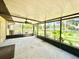 Spacious screened porch with a ceiling fan at 26 Juniper Pass Ln, Ocala, FL 34480