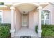 Front entry with covered porch, tiled floor, and glass door at 11696 Sw 71St Cir, Ocala, FL 34476