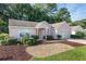 Pink single story home with a two car garage and landscaped yard at 11696 Sw 71St Cir, Ocala, FL 34476