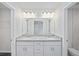 Double vanity bathroom with granite countertop and white cabinets at 24381 Nw Falcon Ave, Dunnellon, FL 34432