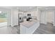 Modern kitchen with white cabinets, granite countertops and stainless steel appliances at 24381 Nw Falcon Ave, Dunnellon, FL 34432