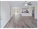 Open living room with grey flooring and kitchen view at 24381 Nw Falcon Ave, Dunnellon, FL 34432
