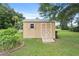Tan storage shed with double doors and a ramp at 10716 Sw 53Rd Cir, Ocala, FL 34476