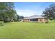 Spacious backyard with large green lawn and house at 10716 Sw 53Rd Cir, Ocala, FL 34476