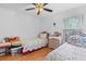 Two twin beds in a well-lit bedroom with ceiling fan at 10716 Sw 53Rd Cir, Ocala, FL 34476