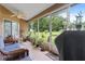 Relaxing screened porch with wicker furniture and ceiling fan at 10716 Sw 53Rd Cir, Ocala, FL 34476