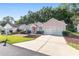 Pink one-story house with a two-car garage and landscaped yard at 11696 Sw 71St Cir, Ocala, FL 34476