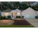 Pink house with two car garage and mature landscaping at dusk at 11696 Sw 71St Cir, Ocala, FL 34476