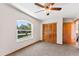 Bedroom with large window, ceiling fan, and double-door closet at 174 Juniper Trl, Ocala, FL 34480