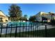Community pool with lounge chairs and fencing at 3507 E Fort King St # 235, Ocala, FL 34470
