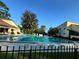 Community pool with lounge chairs and fencing at 3507 E Fort King St # 235, Ocala, FL 34470
