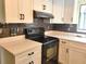 Modern kitchen with white cabinets and dark countertops at 8424 Sw 107Th Pl, Ocala, FL 34481