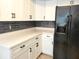 Modern kitchen with white cabinets, new appliances, and a breakfast bar at 8424 Sw 107Th Pl, Ocala, FL 34481