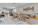 Open living room with ample natural light and view of dining and kitchen areas at 7694 Graben St, Kissimmee, FL 34747
