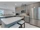 Modern kitchen with large island, stainless steel appliances, and quartz countertops at 7694 Graben St, Kissimmee, FL 34747